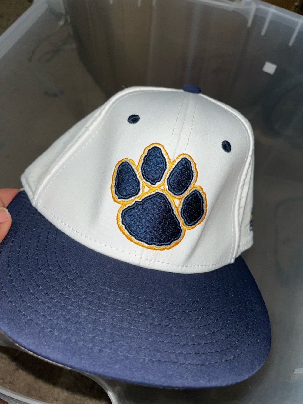 The Game White and Navy Paw Print Baseball Hat with Gold Outline